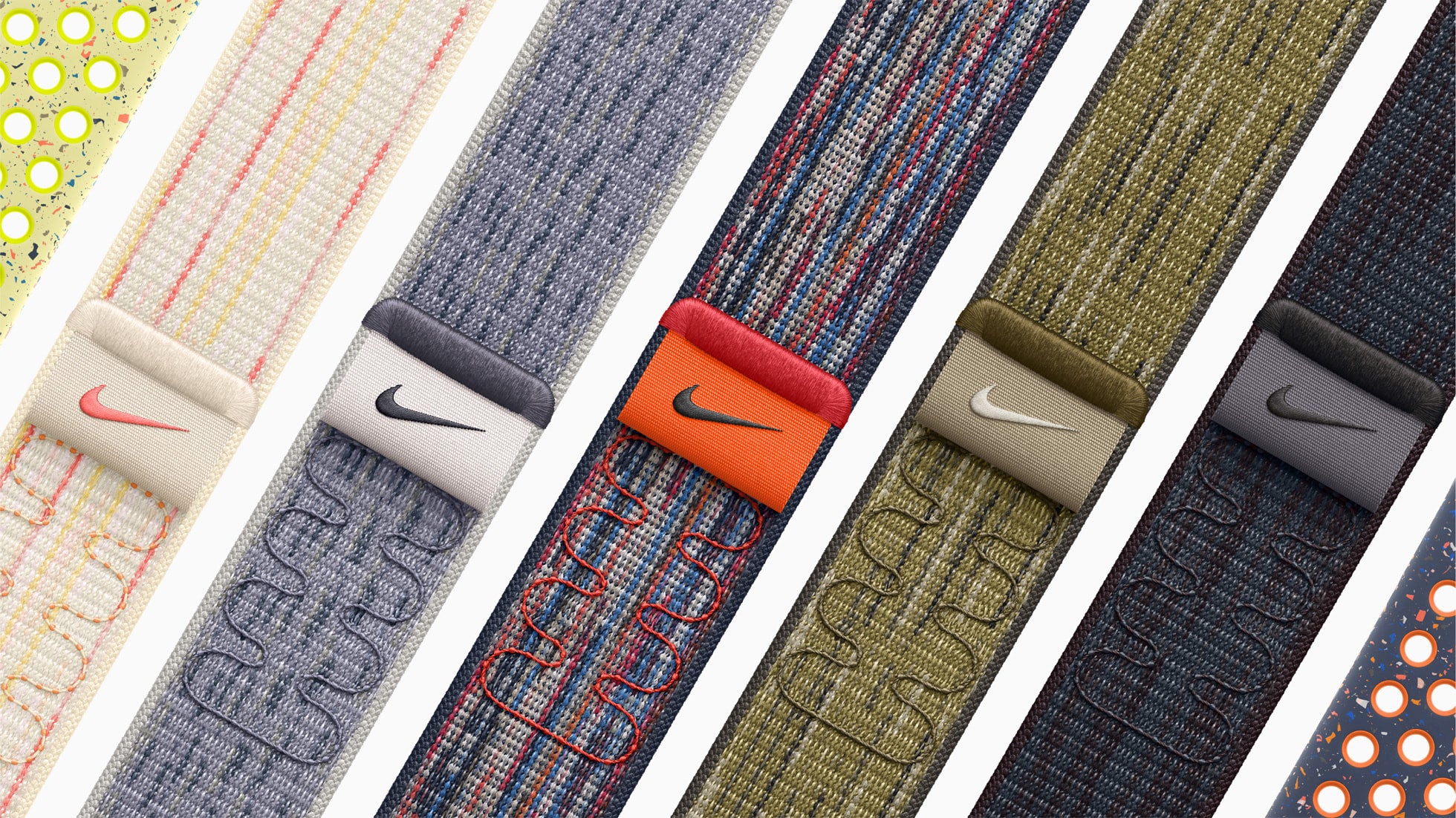 Close-up of six colorful Nike wristbands with textured fabric and embroidered designs